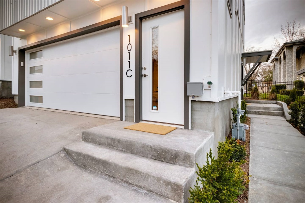 The garage can accommodate two full-size cars and has an entrance for guests