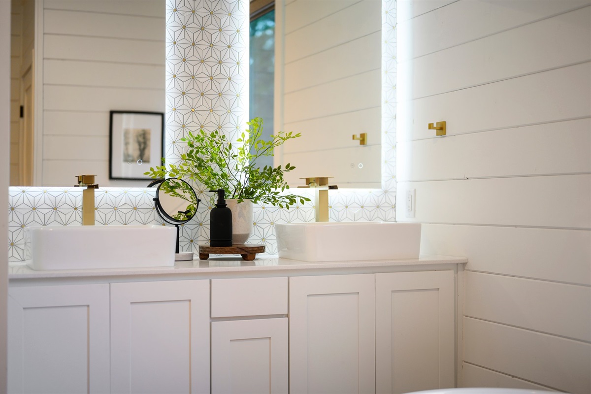 The double vanity with modern vessel sinks provides plenty of space to get ready.