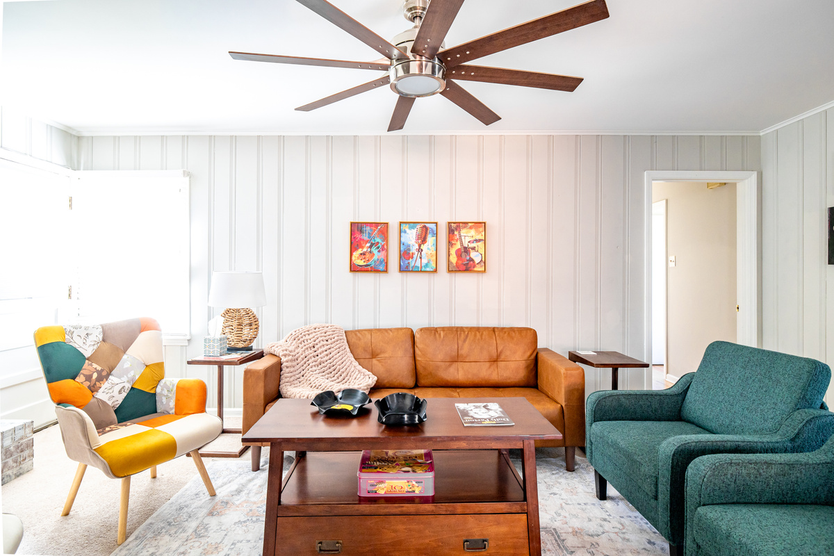 Living room that opens to the kitchen. Plenty of seating, decorative fireplace, TV