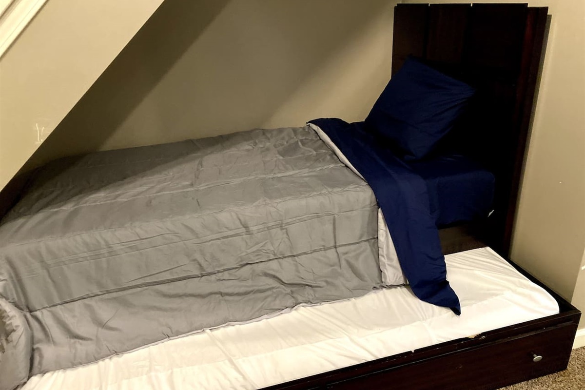 Turning under-stair space into sweet dreams—twin beds with a hidden trundle for ultimate comfort 