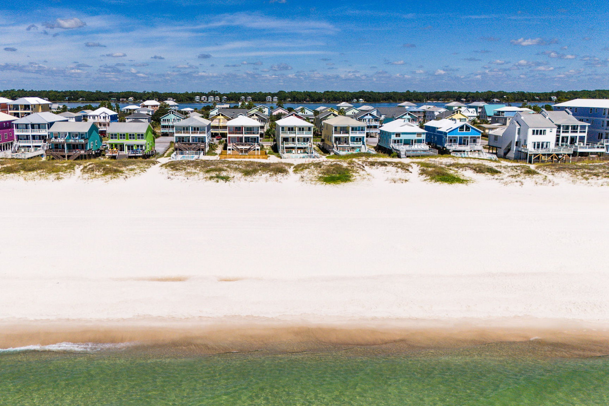 Aerial beach view showing the beautiful white-sand shoreline and coastal community near the vacation rental.