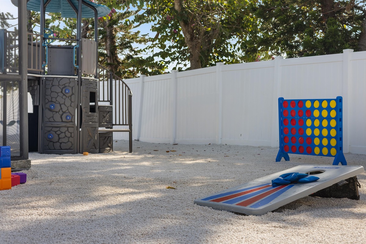 Our backyard boasts a plethora of fun activities - a connect, cornholes, blocks, a playset, and an ax thrower.