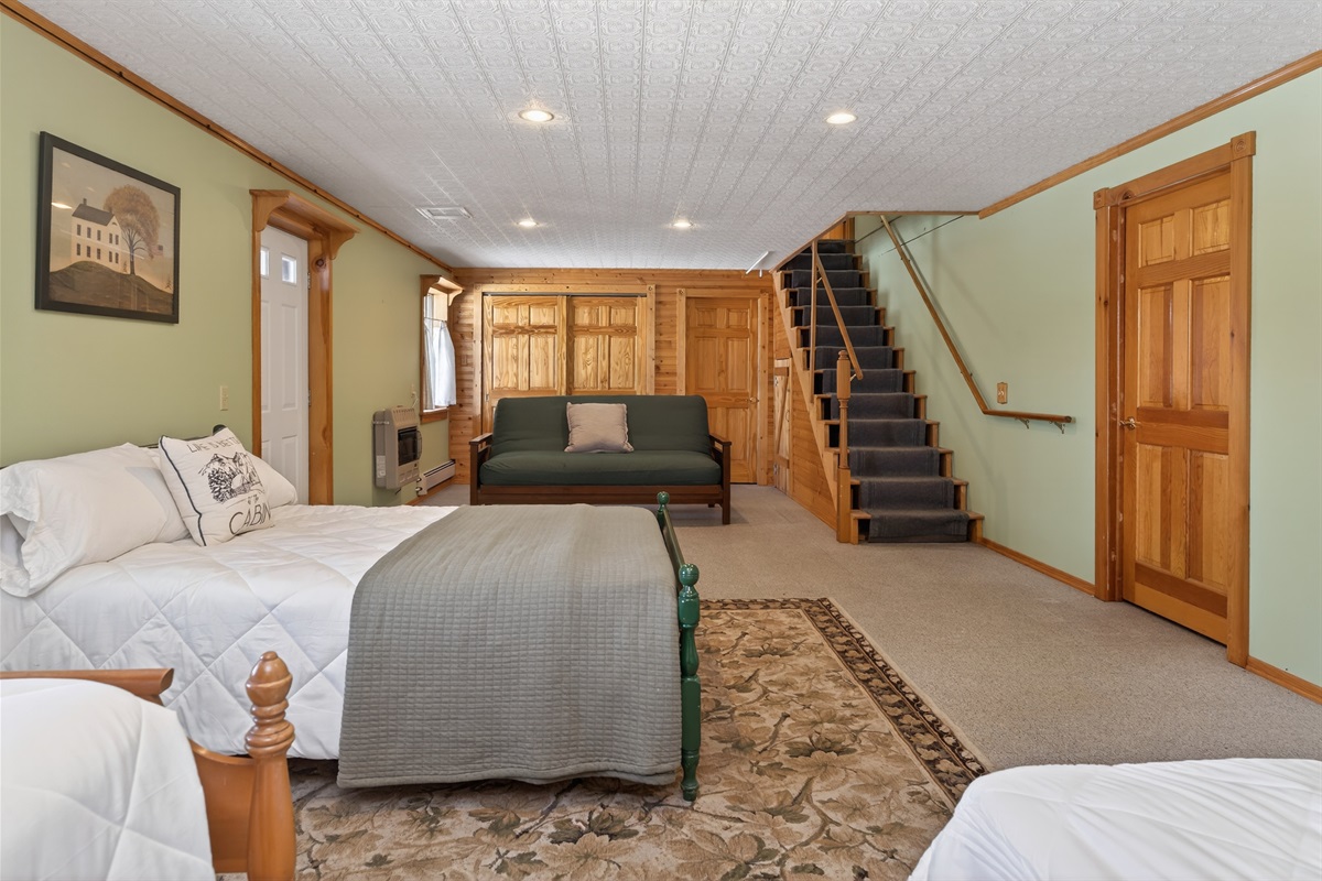 Lower level bedroom # 4 with two twins, a double bed and a queen futon 