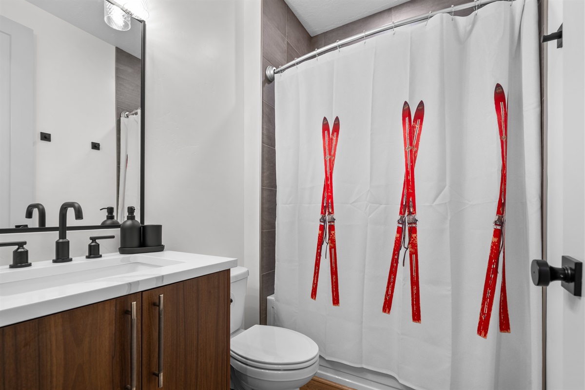 Mountain-themed bathroom accents add ski-lodge charm.