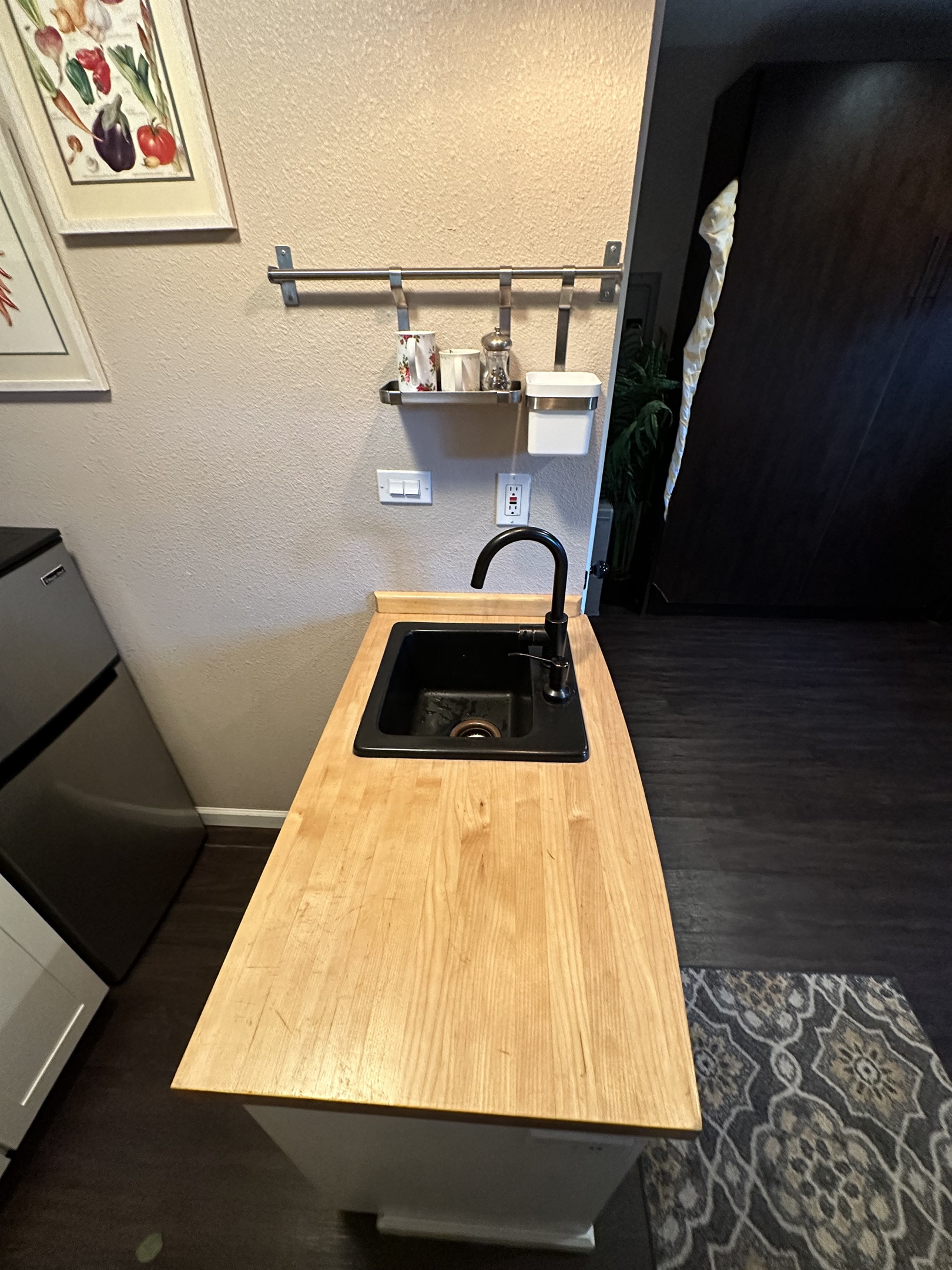 Simple kitchen area w/ wood countertop & easy prep space