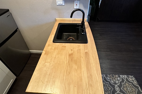 Simple kitchen area w/ wood countertop & easy prep space