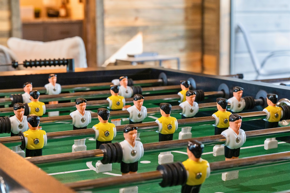 The foosball table invites guests to engage in some playful competition.