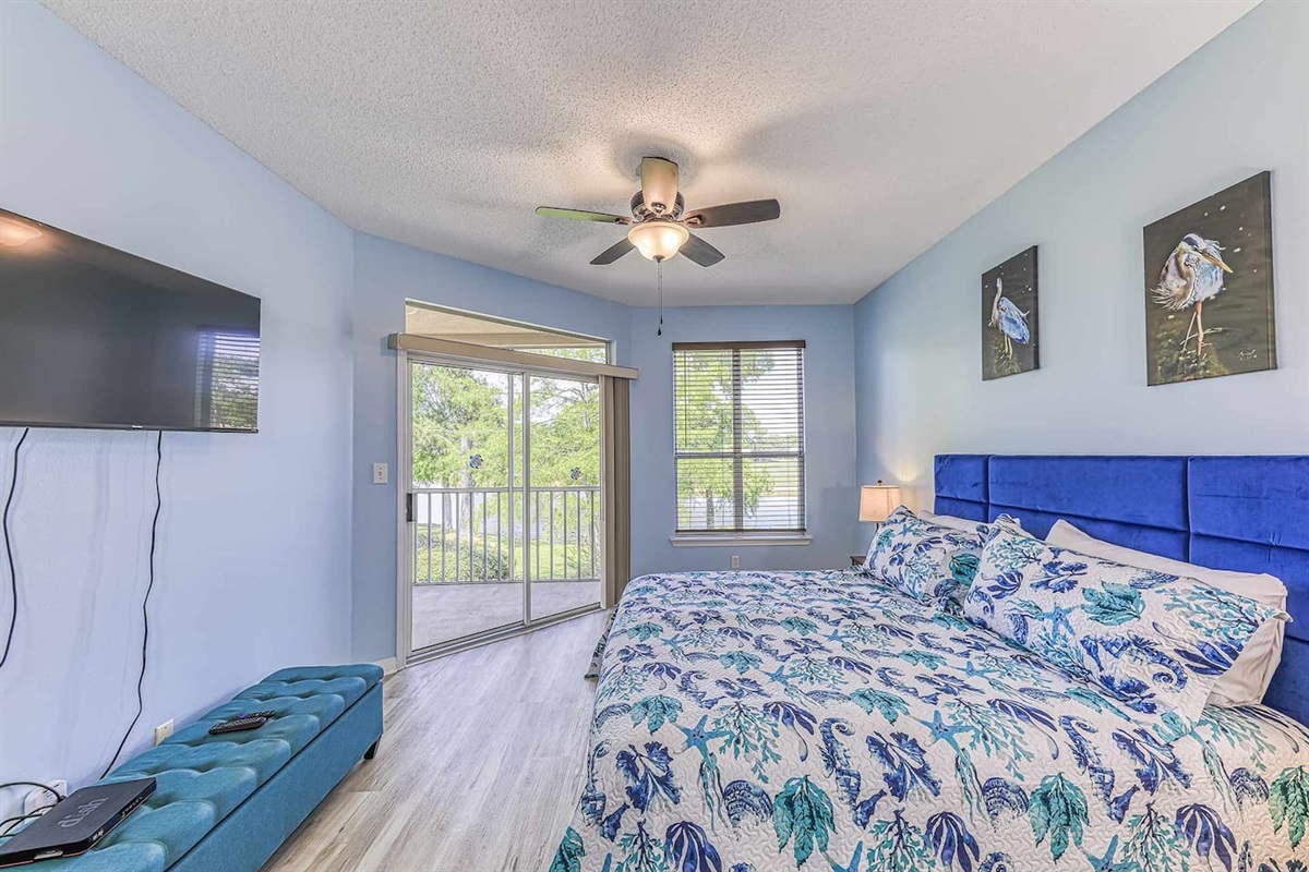 Bedroom Retreat: Wake up to vibrant decor and serene views in this stylish, bright room!