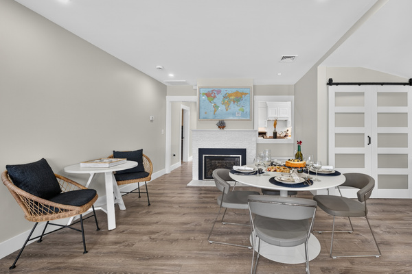 Modern dining area with stylish seating, fireplace, and open flow into the living space.