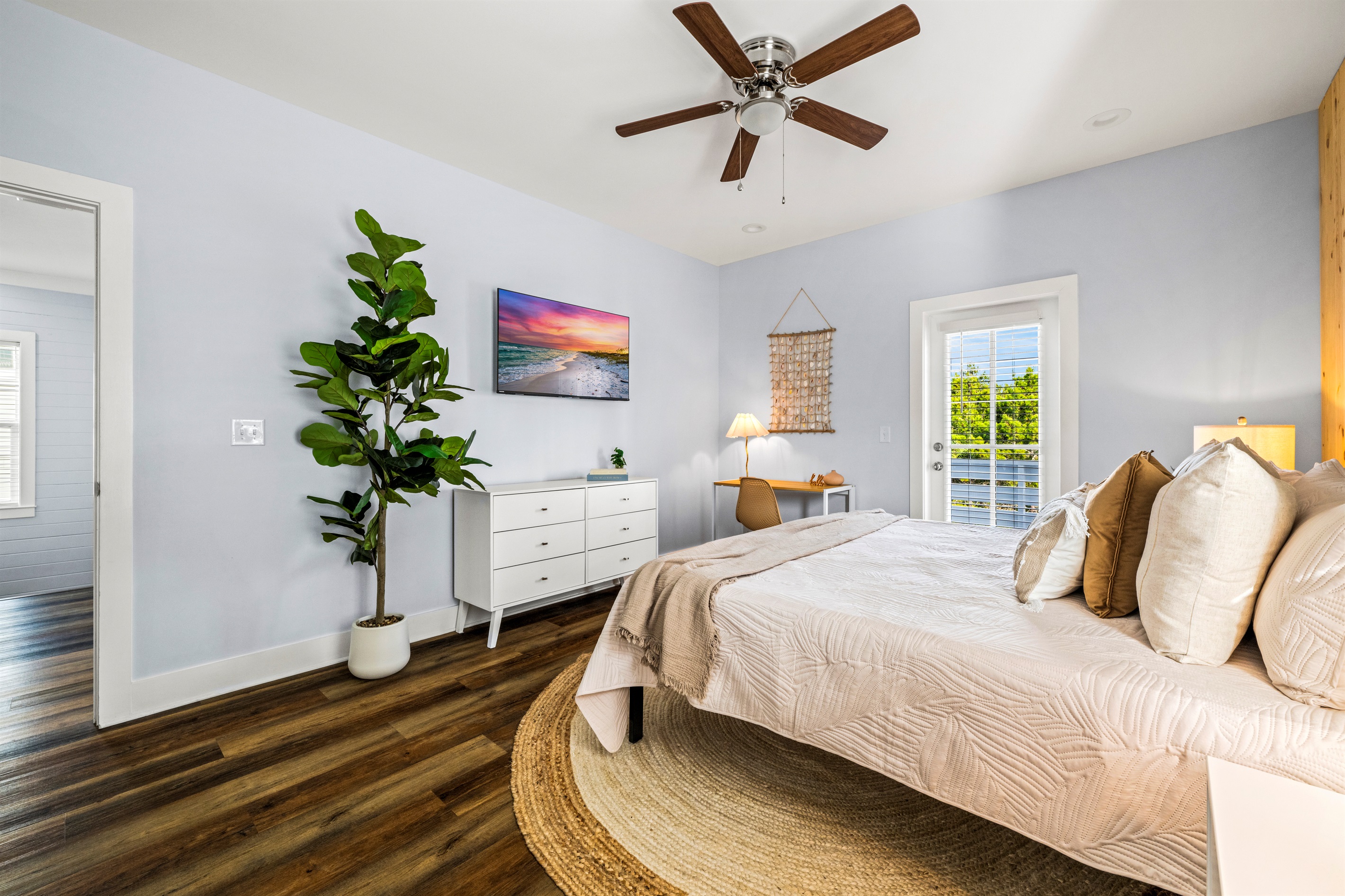Relax in this bright, calming bedroom with coastal textures and warm wood tones. The perfect place to recharge after a full day of sun and sand.
