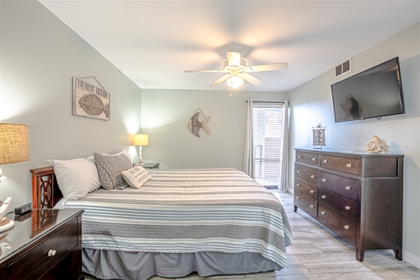 Master bedroom with king bed, ceiling fan, smart TV and ensuite bathroom