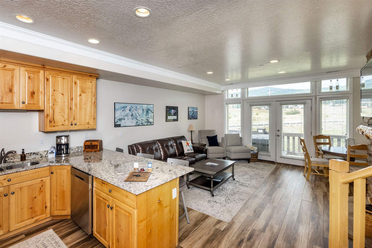 Cook, chat, and unwind in this bright open kitchen and living area made for together time with scenic mountain views - perfect for entertaining or cozy nights in.