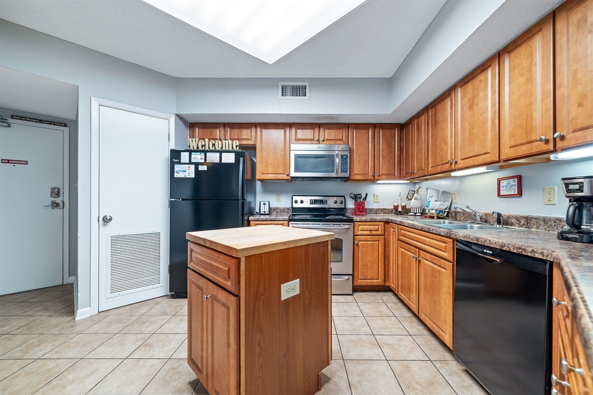 A tidy and functional kitchen countertop. This organized space, complete with coffee makers, a toaster, and a paper towel holder, makes everyday tasks a breeze.