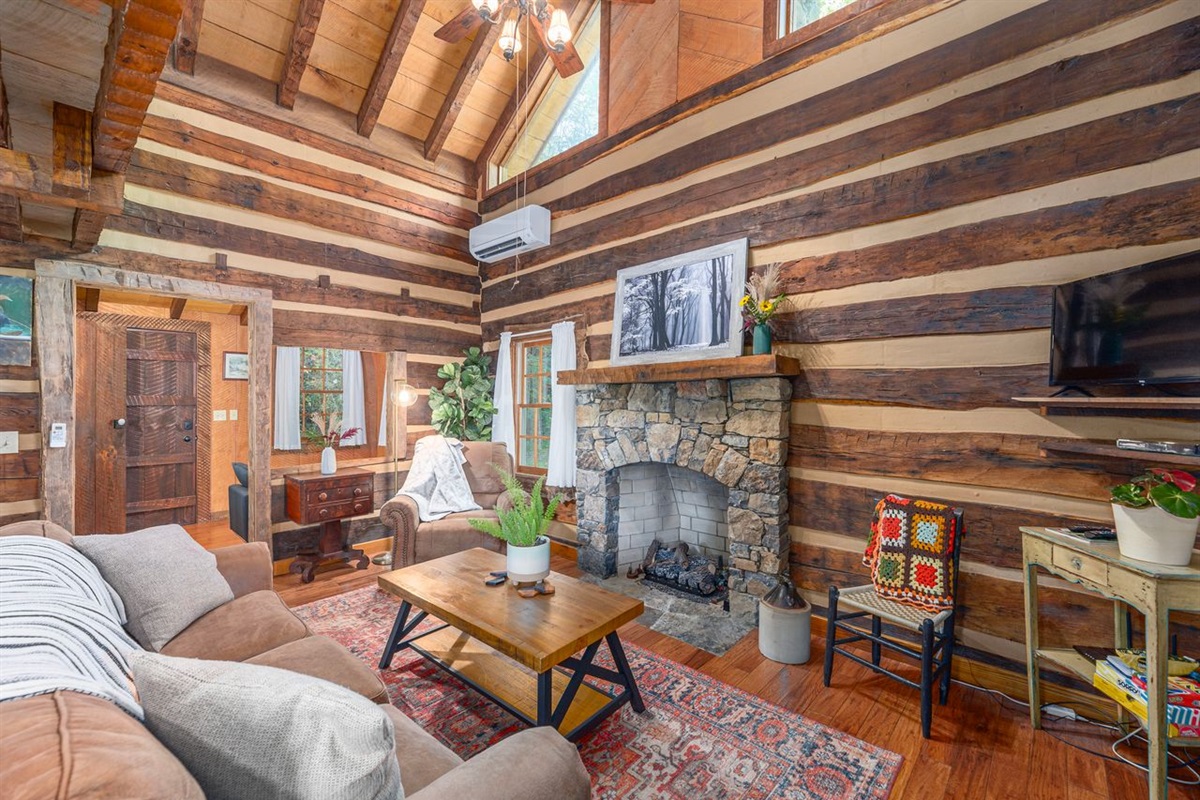 Walking in to the cabin you may first notice the fireplace, or the wood. Both at right at home here in the mountains of Western North Carolina. 