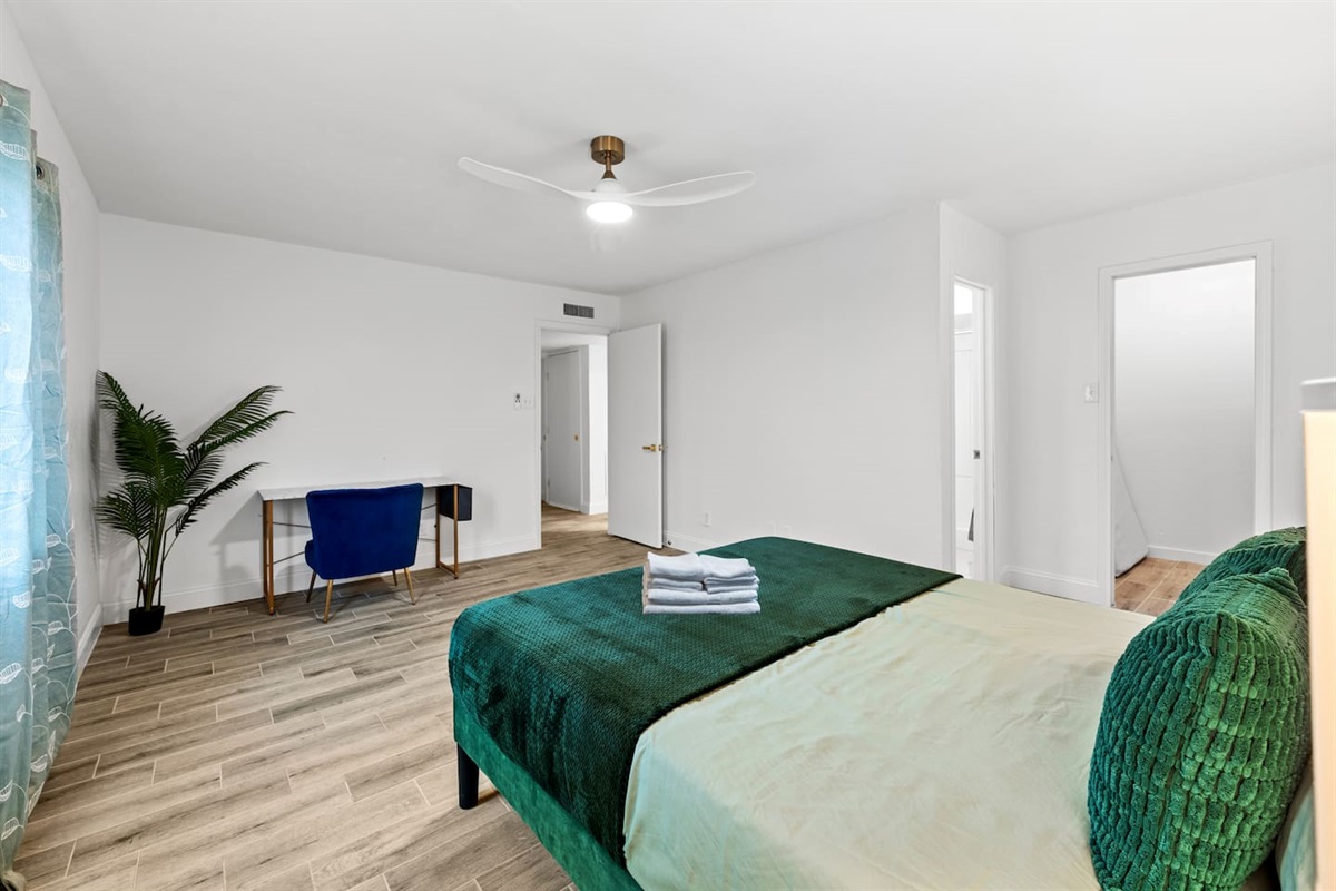 Retreat to a luxurious king bedroom with soft lighting, calming tones, and a desk for moments of focus.