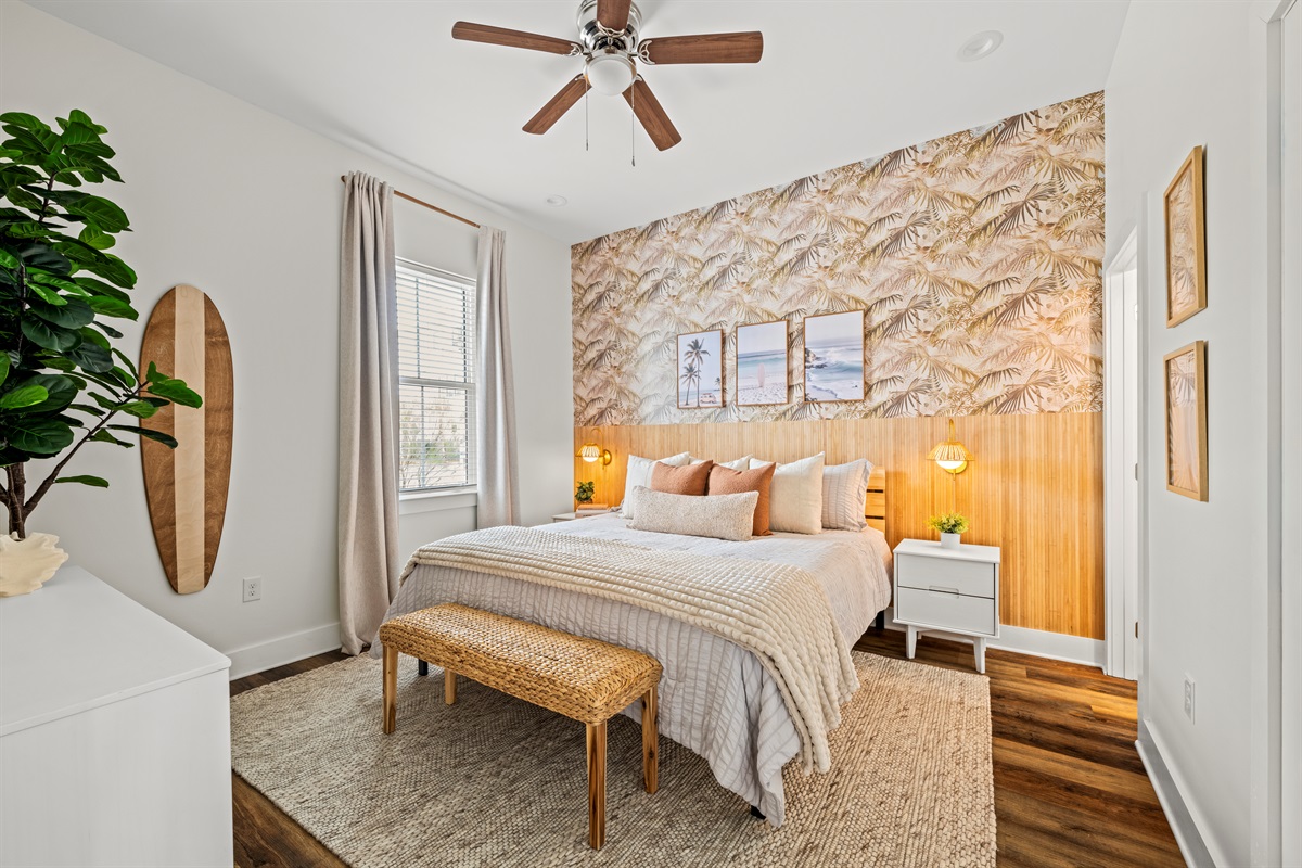 A calm coastal bedroom designed for restful nights after sunny days at Miramar Beach. Soft bedding, warm lighting, and relaxed beach style.
