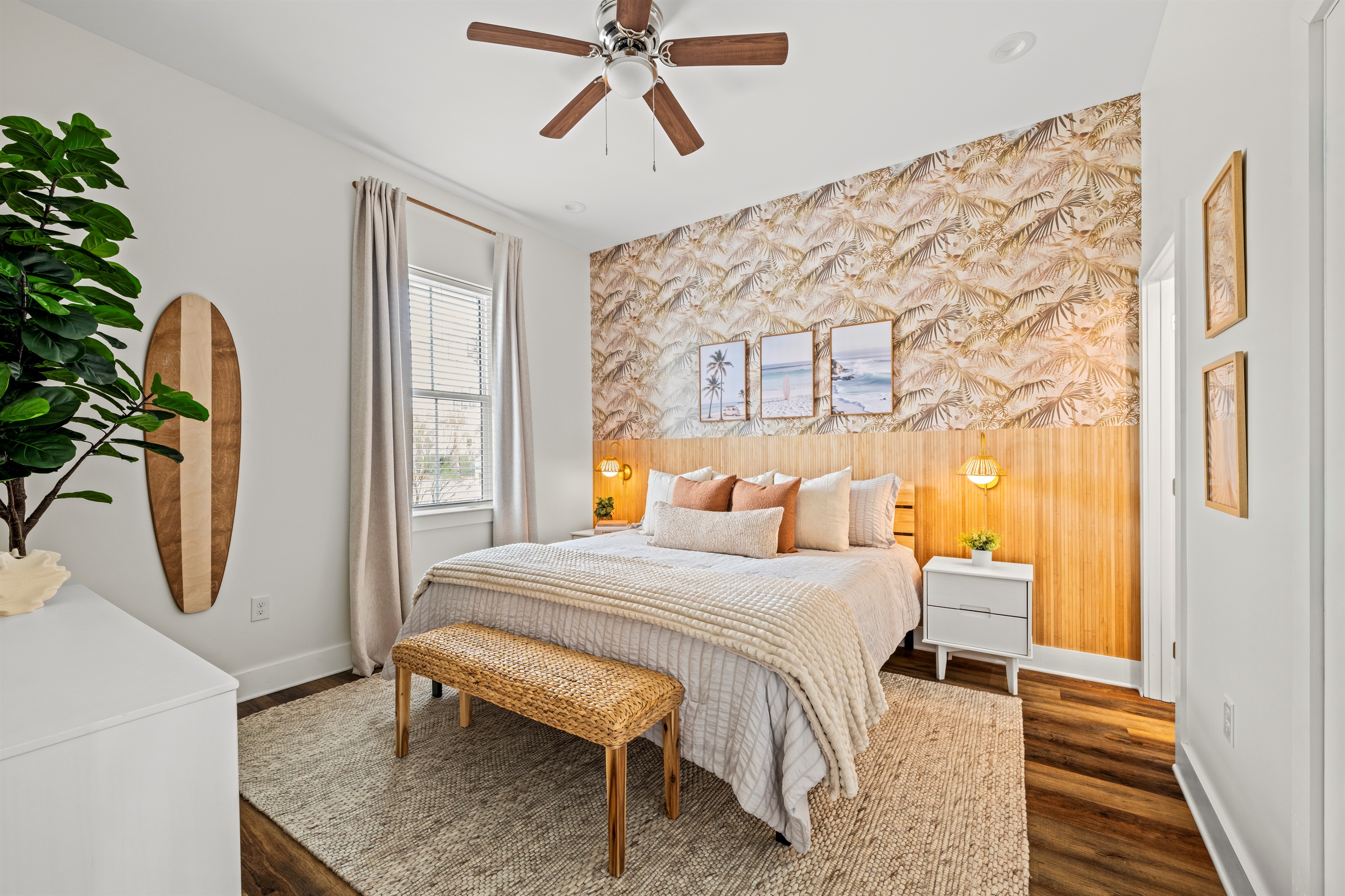 A calm coastal bedroom designed for restful nights after sunny days at Miramar Beach. Soft bedding, warm lighting, and relaxed beach style.