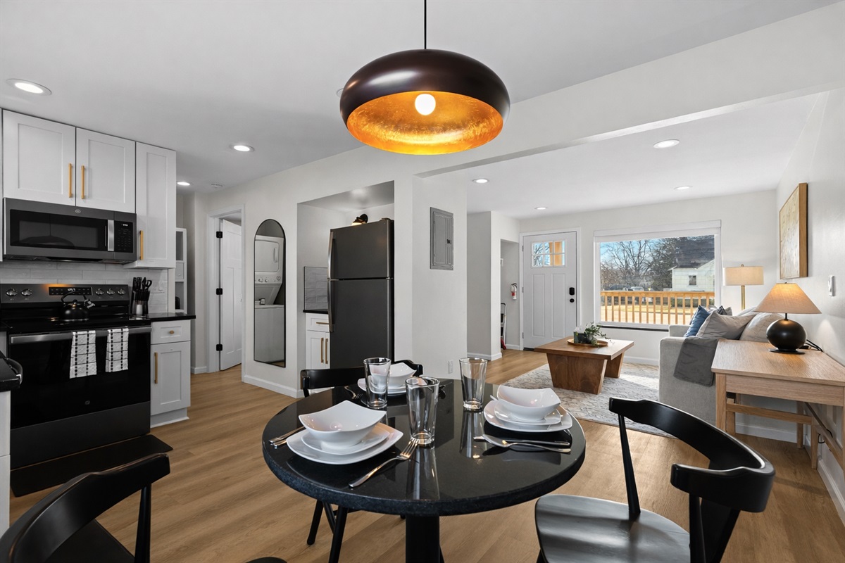Open-concept dining and kitchen area with modern finishes, warm lighting, and seamless flow into the living space—perfect for meals, entertaining, and relaxing together.