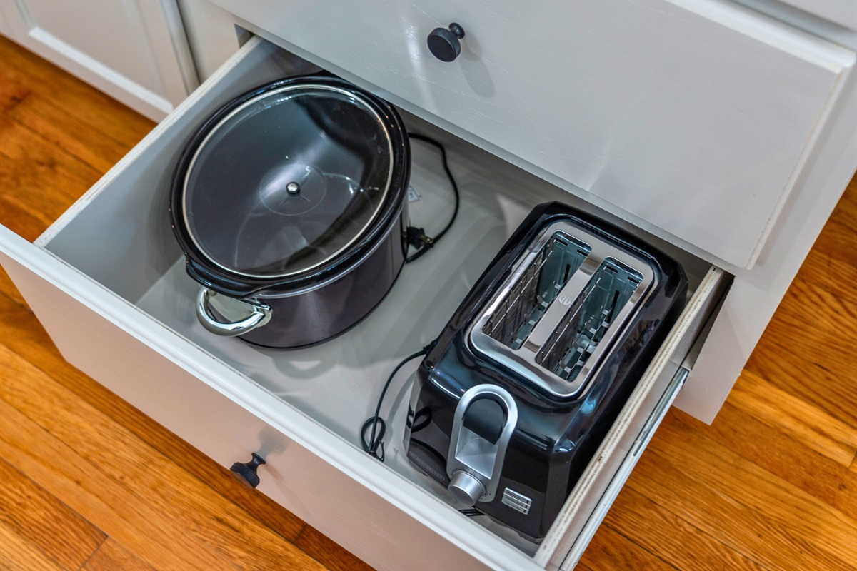 Cabinets stocked with cookware, including pots and pans, ensure you have everything needed for cooking during your visit.