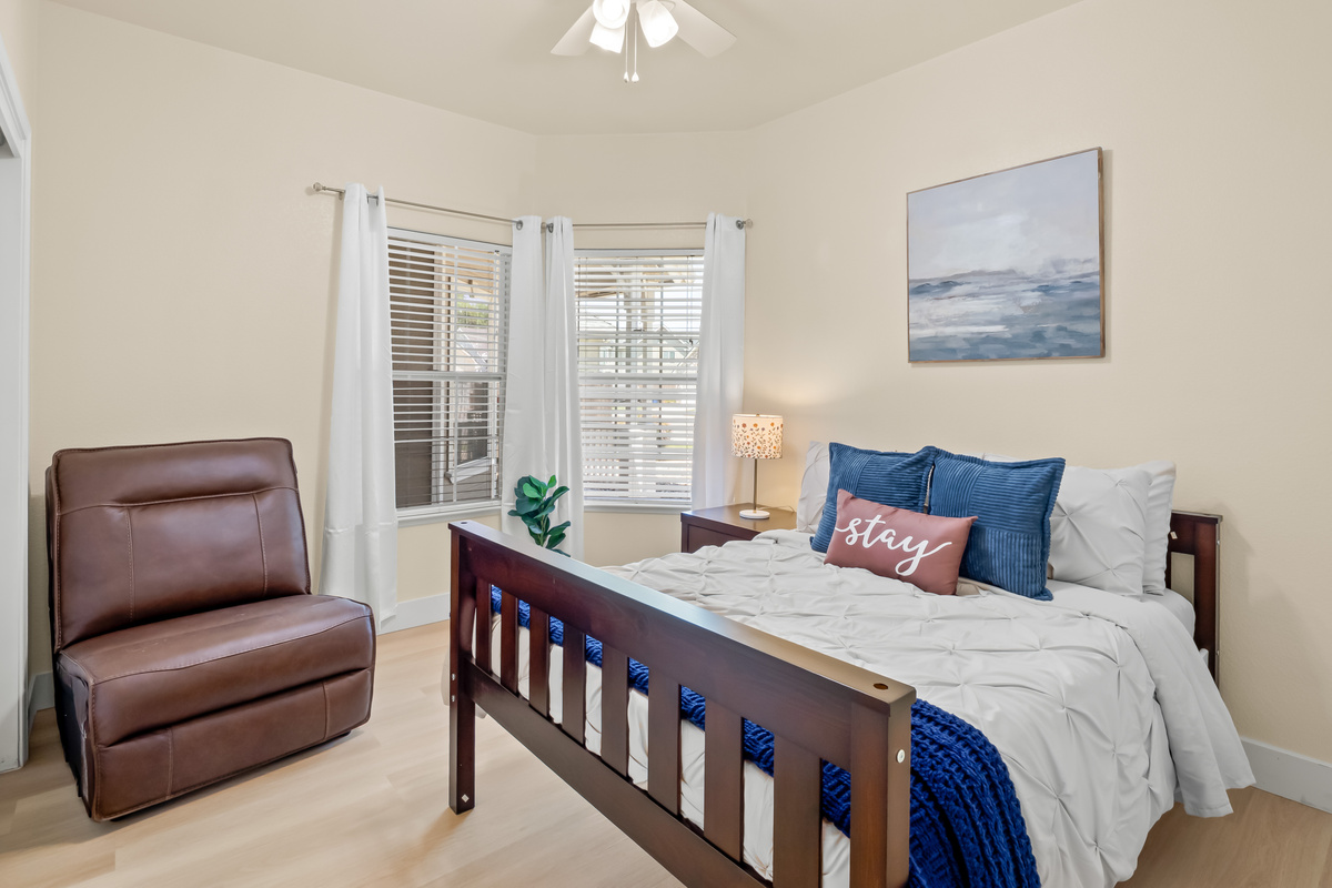 Rest easy in this cozy and inviting bedroom featuring a comfortable queen bed, soft linens, and plenty of natural light. The relaxing atmosphere makes it the perfect retreat after a day of exploring.