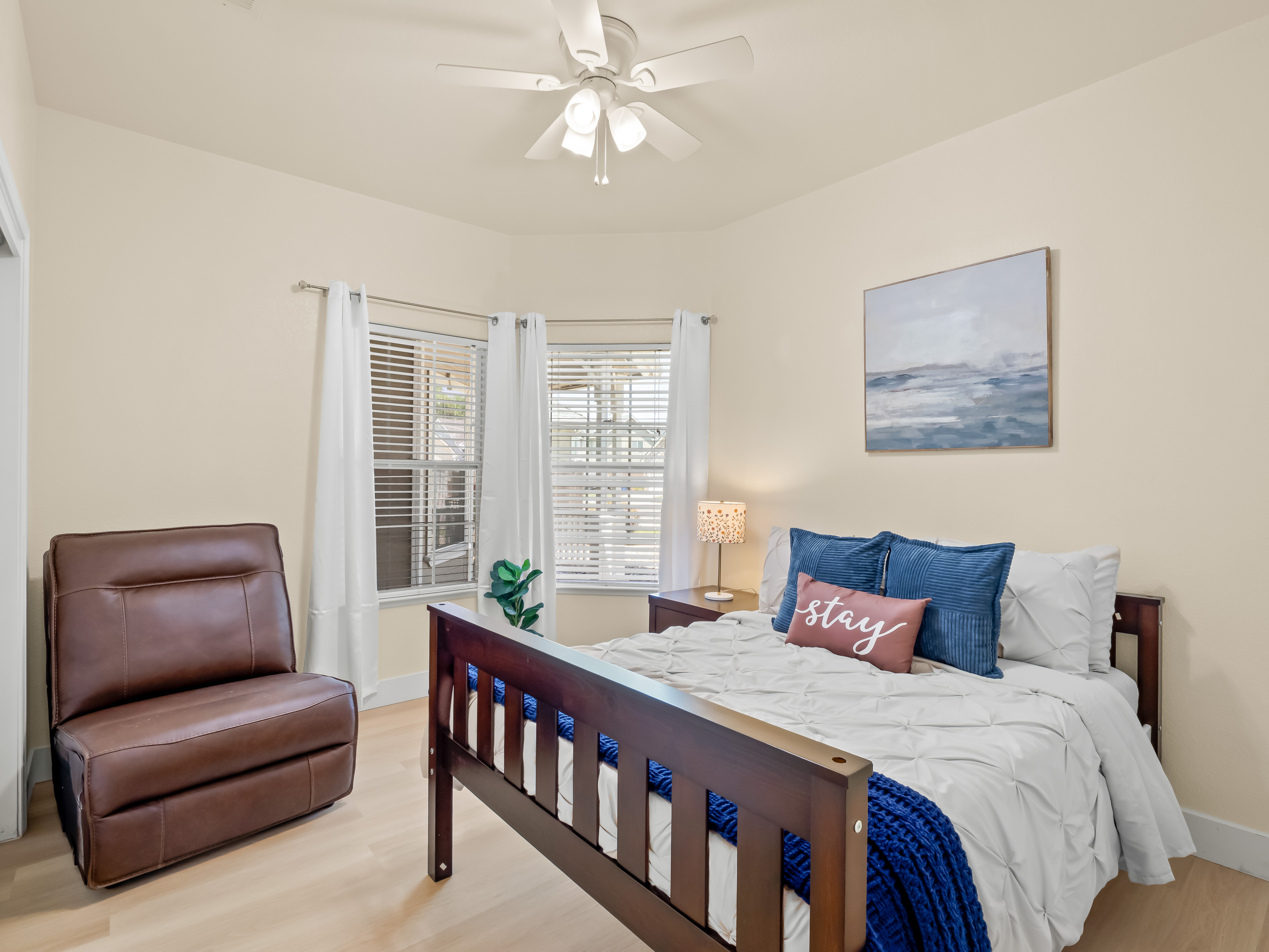 Rest easy in this cozy and inviting bedroom featuring a comfortable queen bed, soft linens, and plenty of natural light. The relaxing atmosphere makes it the perfect retreat after a day of exploring.