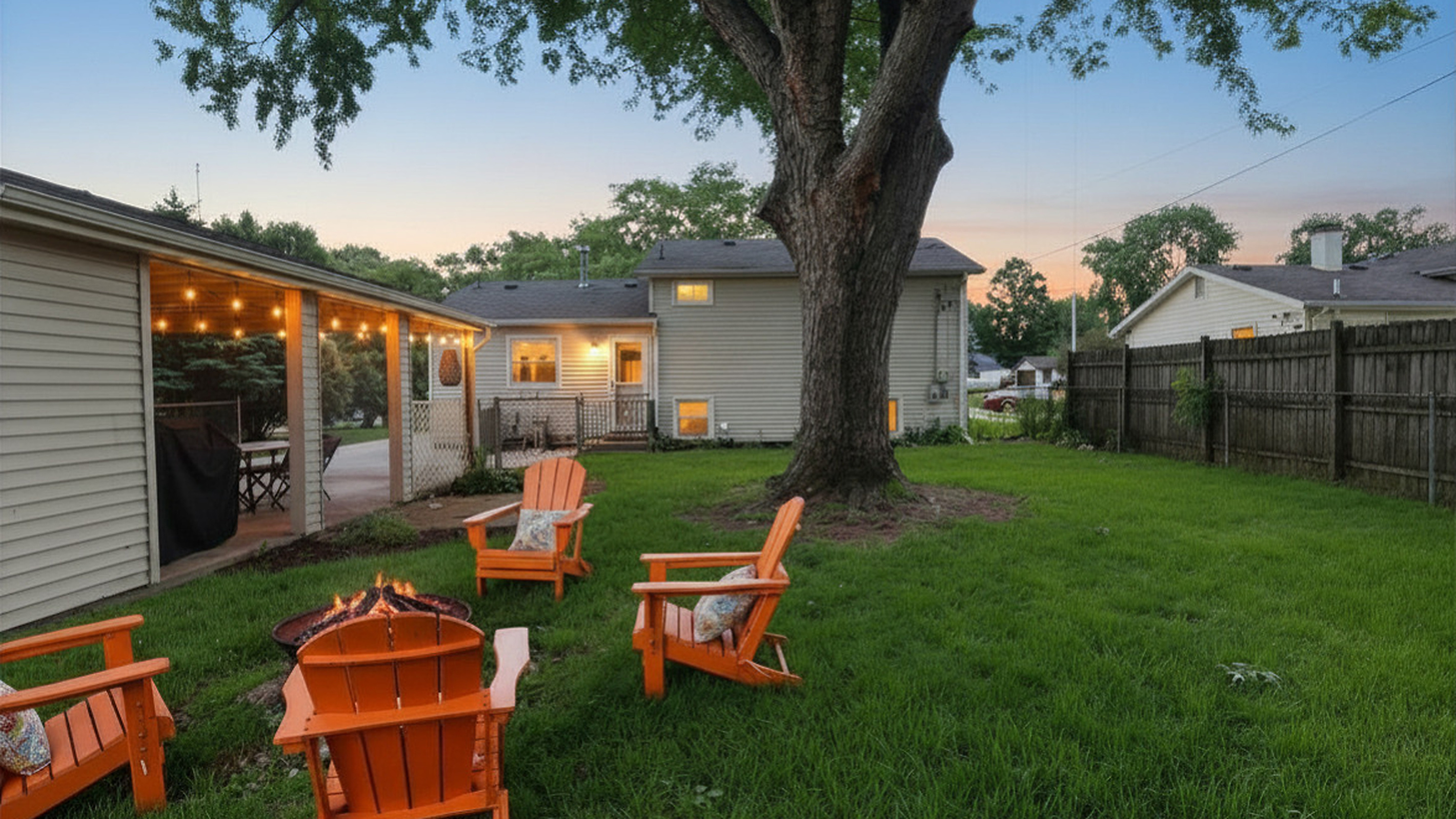 End the day around the fire pit under glowing café lights and mature shade trees.
