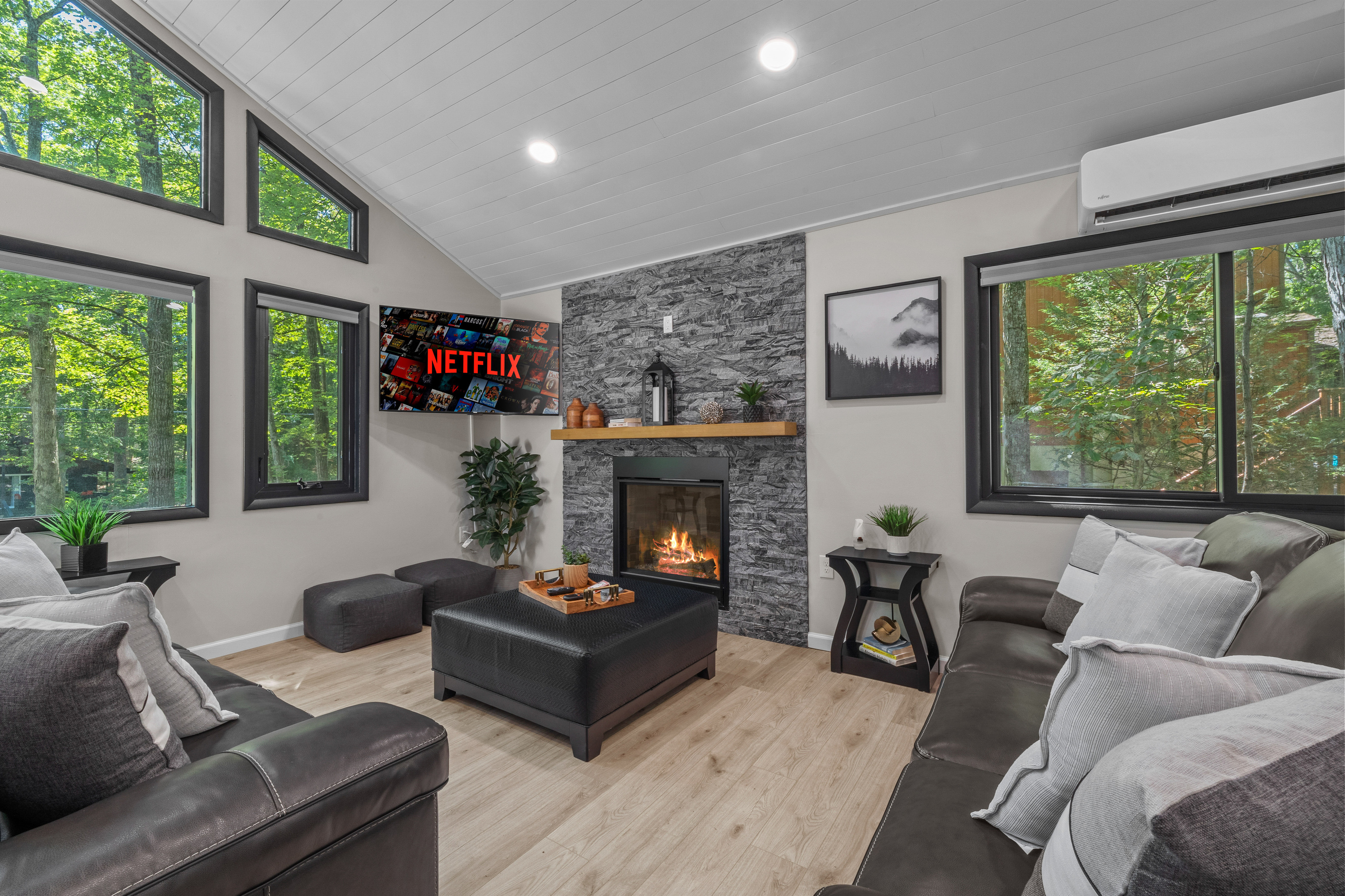Unwind on leather couch by the remote-controlled gas fireplace