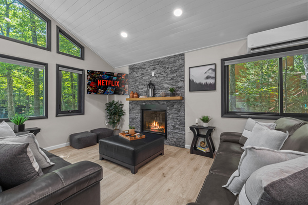 Unwind on leather couch by the remote-controlled gas fireplace