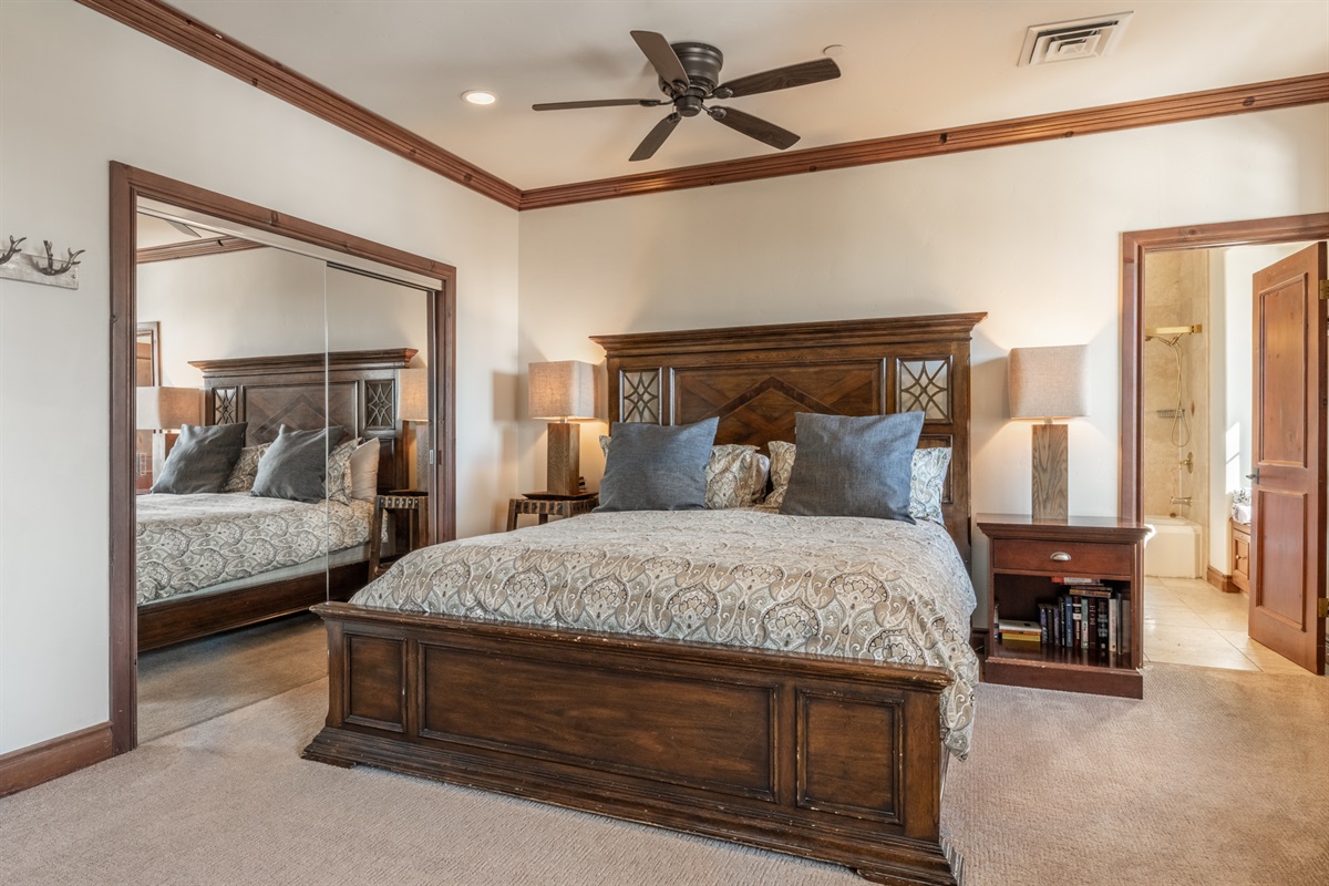 The primary suite is a true retreat, featuring a king bed, gas fireplace, daybed, en-suite bath, and serene mountain ambiance. 