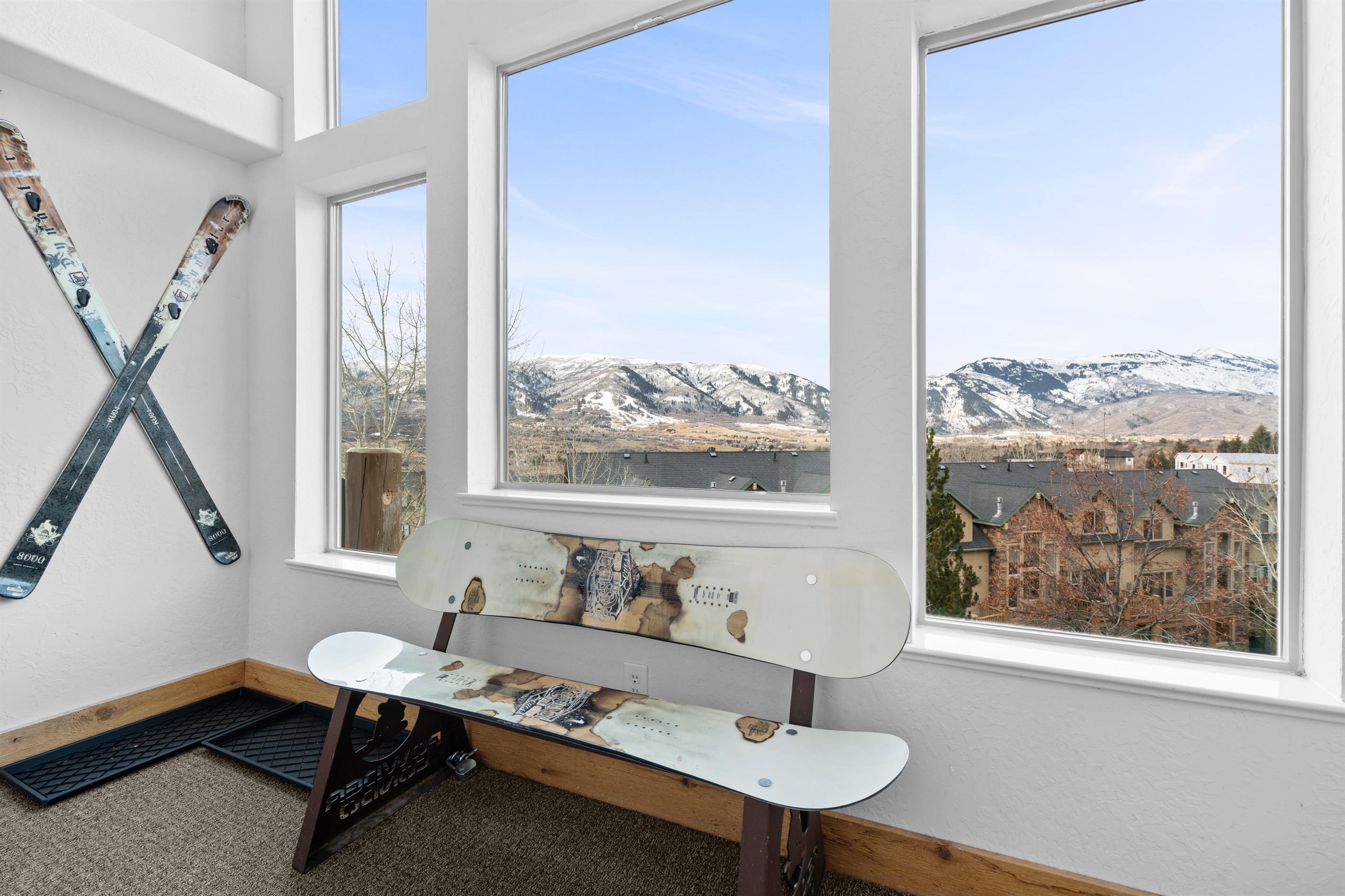 Unique entryway bench crafted from snowboards, paired with beautiful mountain views.