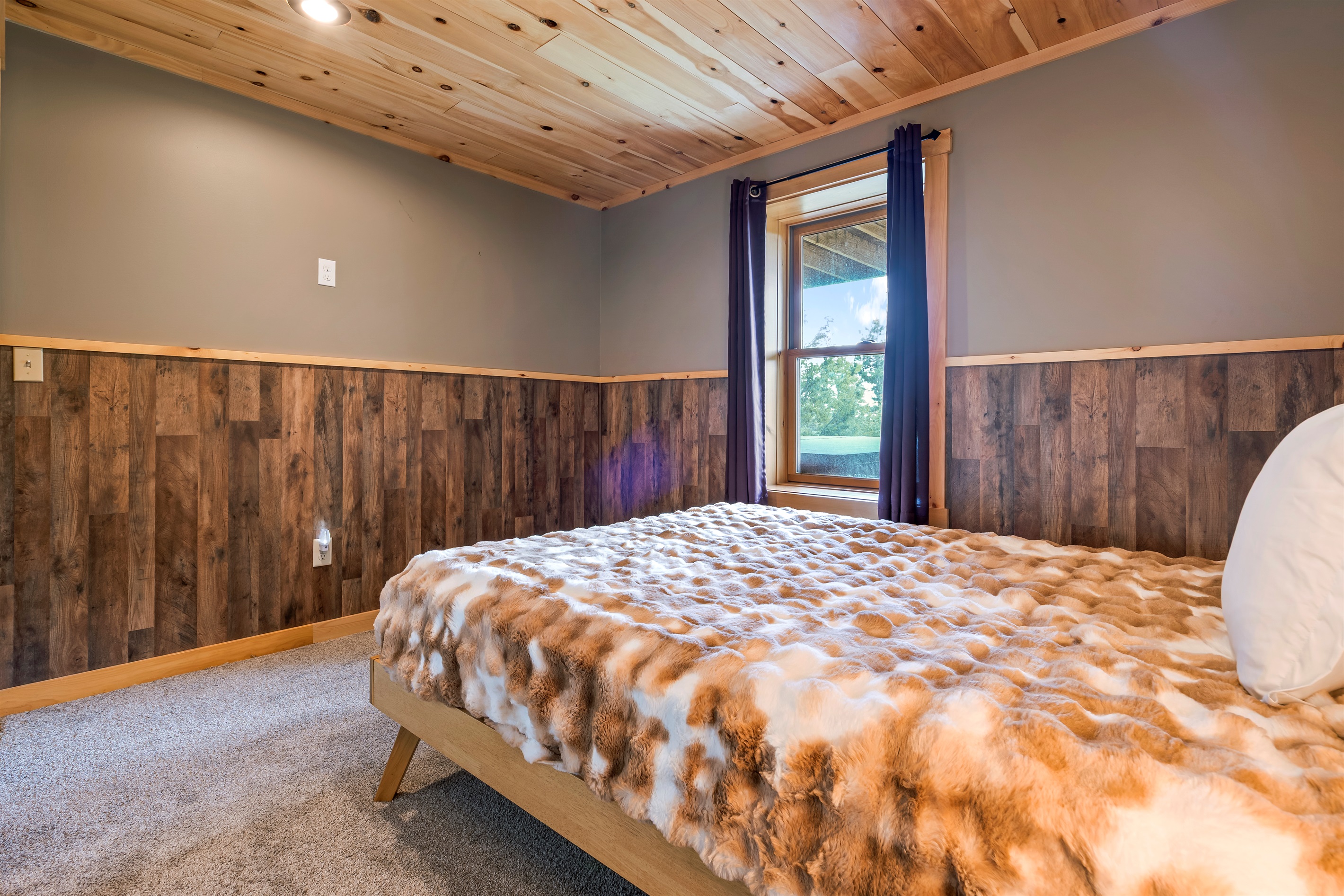 Located on the lower level, the third bedroom is connected to the bunk room, with a door for privacy.
