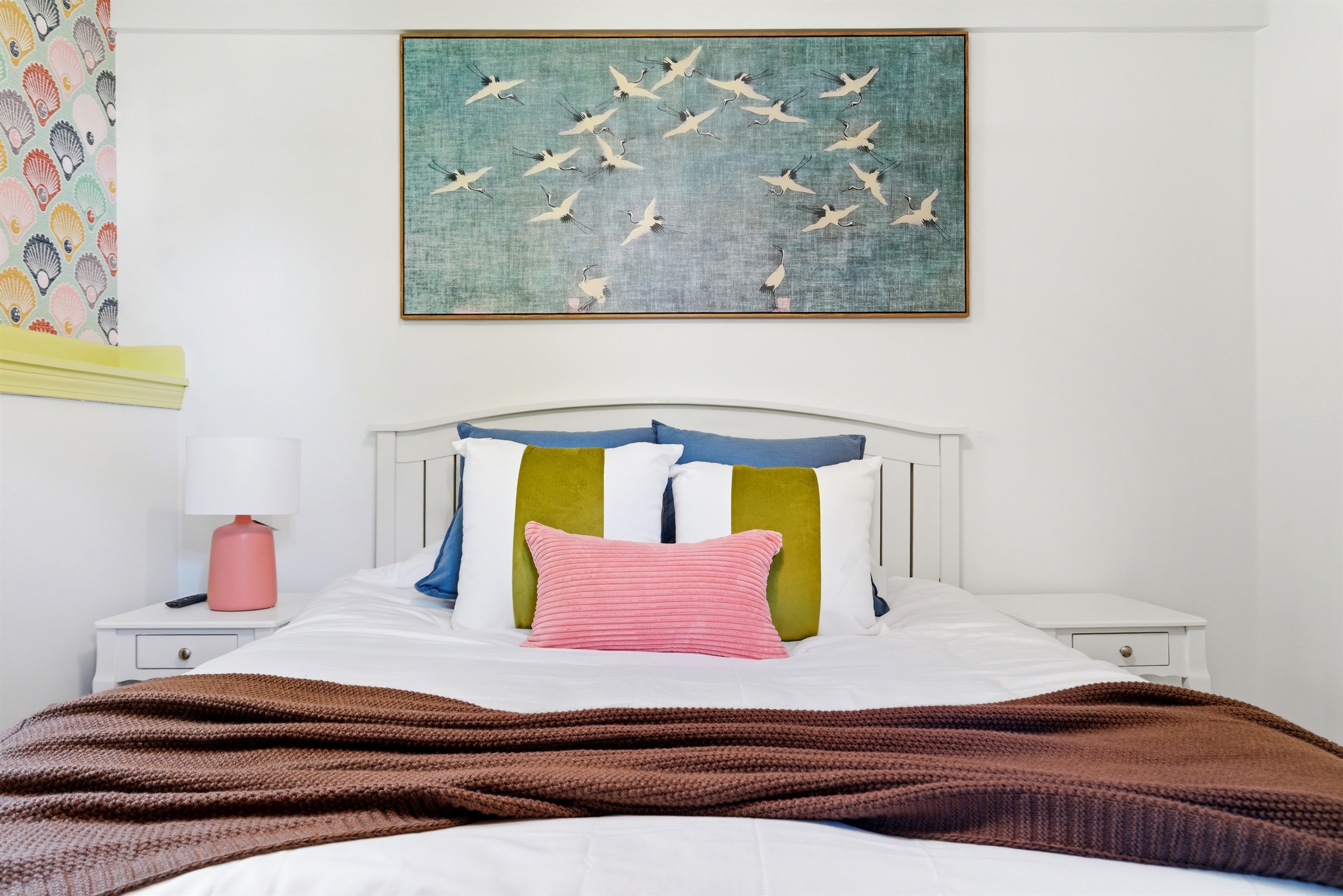 A cozy twin trundle bed setup complete with two bedside nightstands, offering a comfortable and well-balanced space for rest.