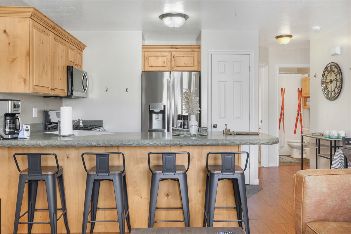 Pull up a seat at the bar—perfect for morning coffee, quick bites, or catching up with the group.