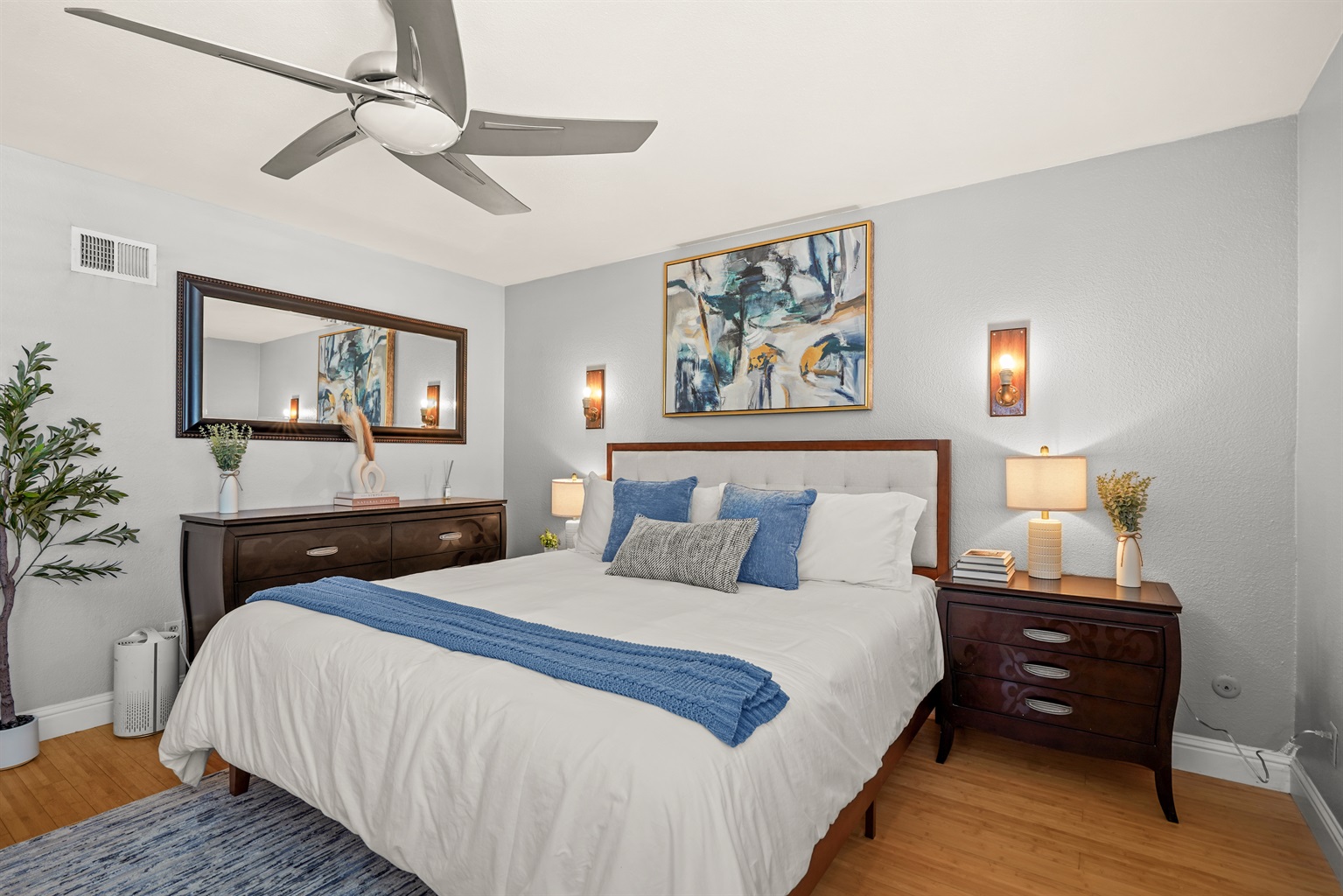 Spacious upstairs primary suite featuring a king bed and ensuite bathroom with dual sinks.