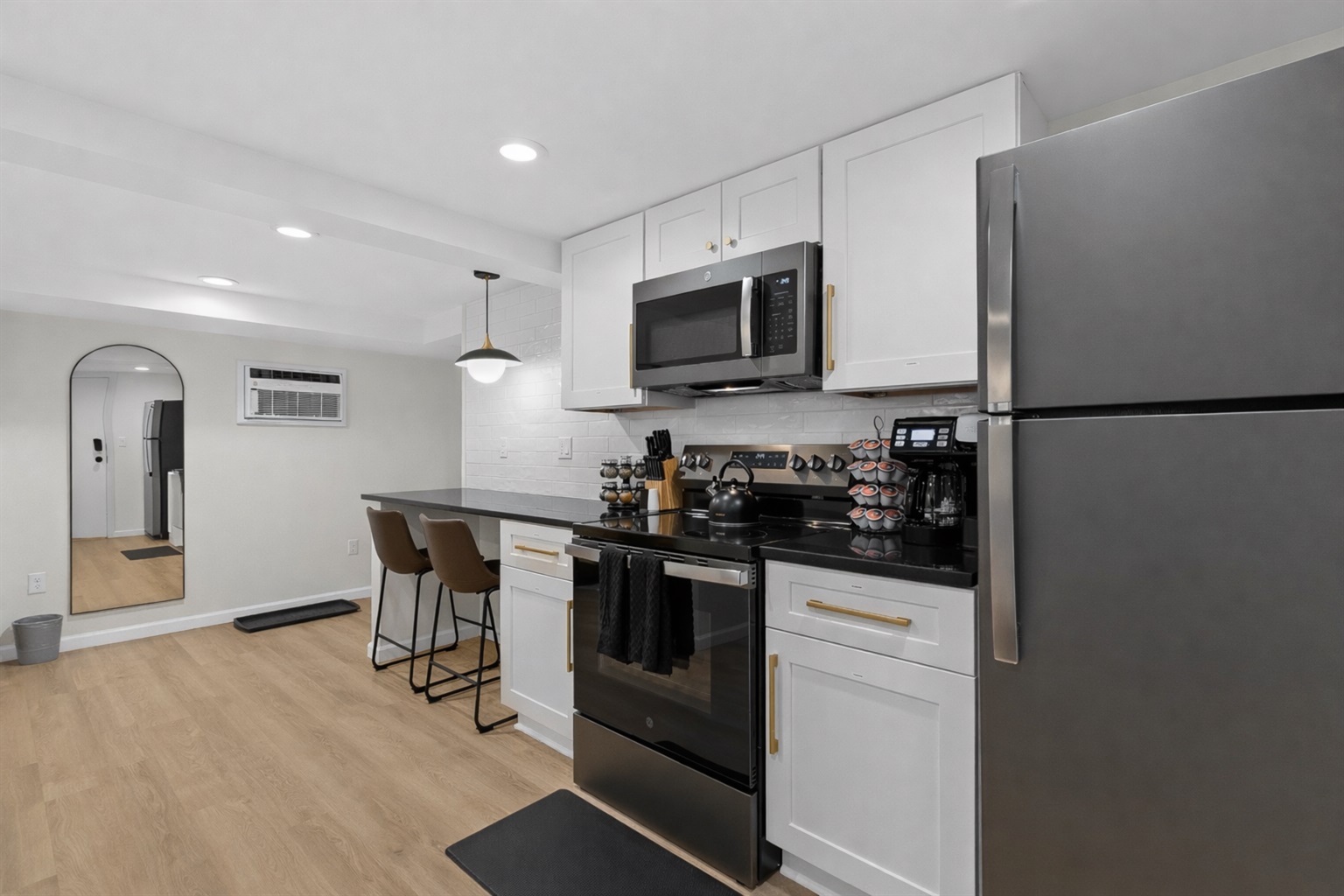 Open, modern kitchen layout with stainless appliances, bar seating, and sleek finishes—perfect for cooking, dining, and enjoying a comfortable stay.
