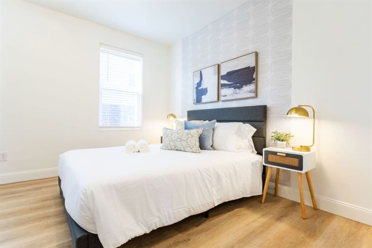 Luxurious king-sized bedroom featuring a unique, eye-catching bed frame for a stylish and comfortable stay.
