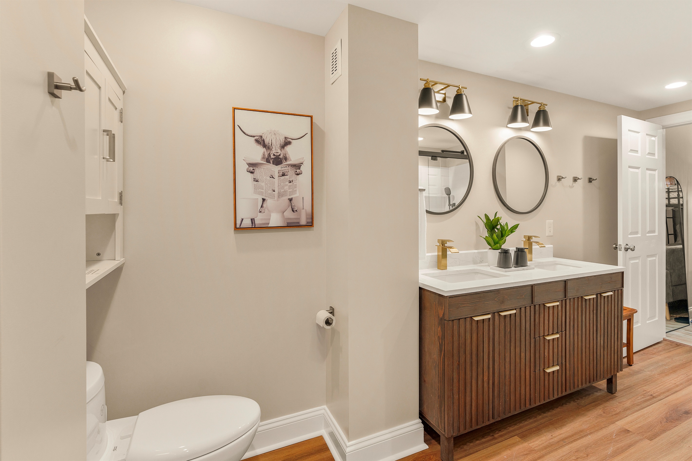 A spa-inspired retreat with a twist. Newly built with dual entry, this bath offers double sinks, gold fixtures, and relaxed luxury—perfect for access and ambiance