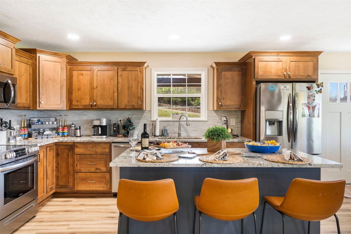 Chef's kitchen with custom cabinets and stainless steel appliances.