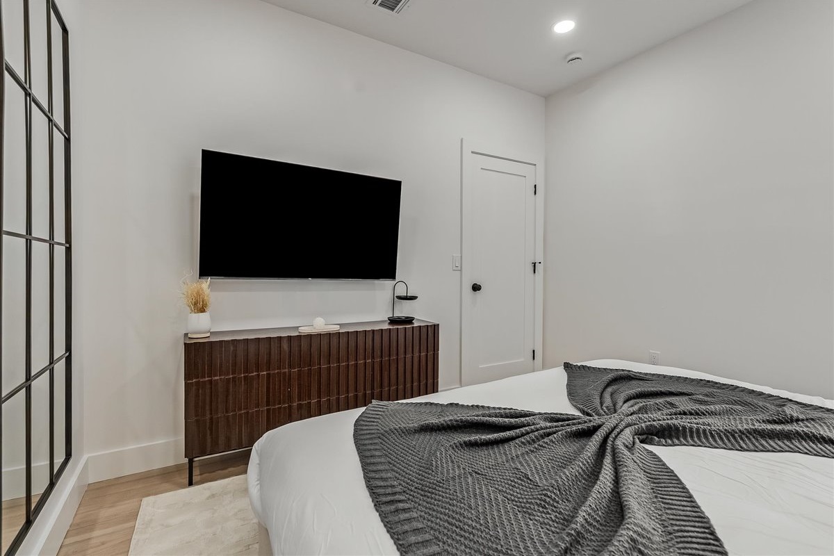 Spacious bedroom with king-size beds and TVs.