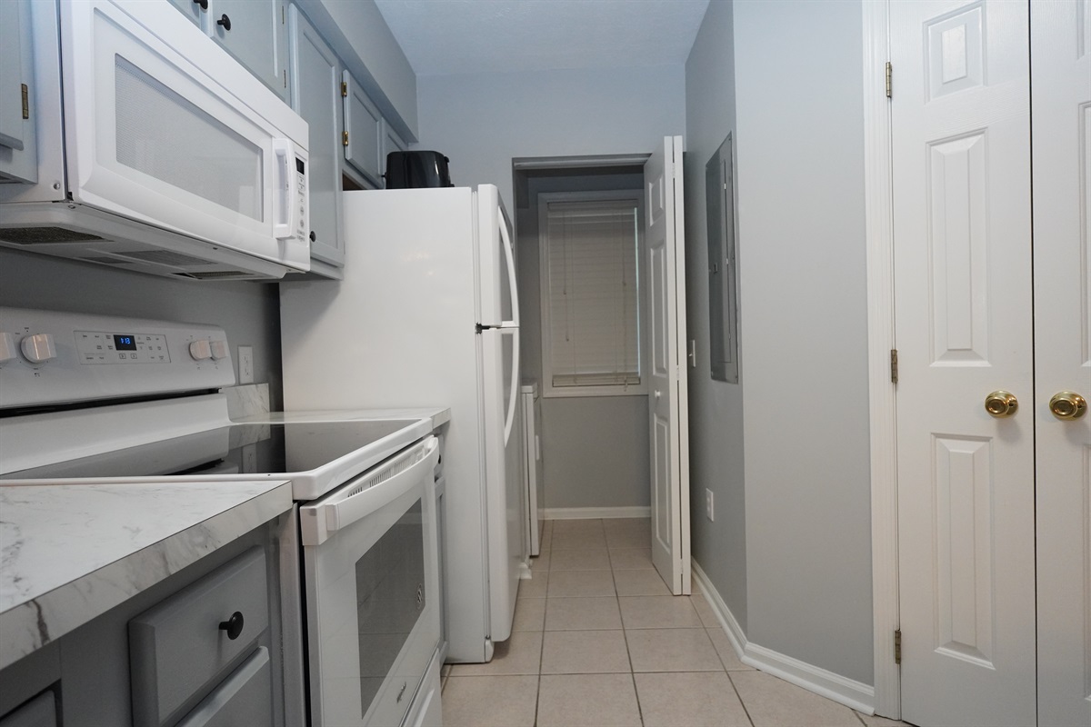 Kitchen leading to washer/dryer access