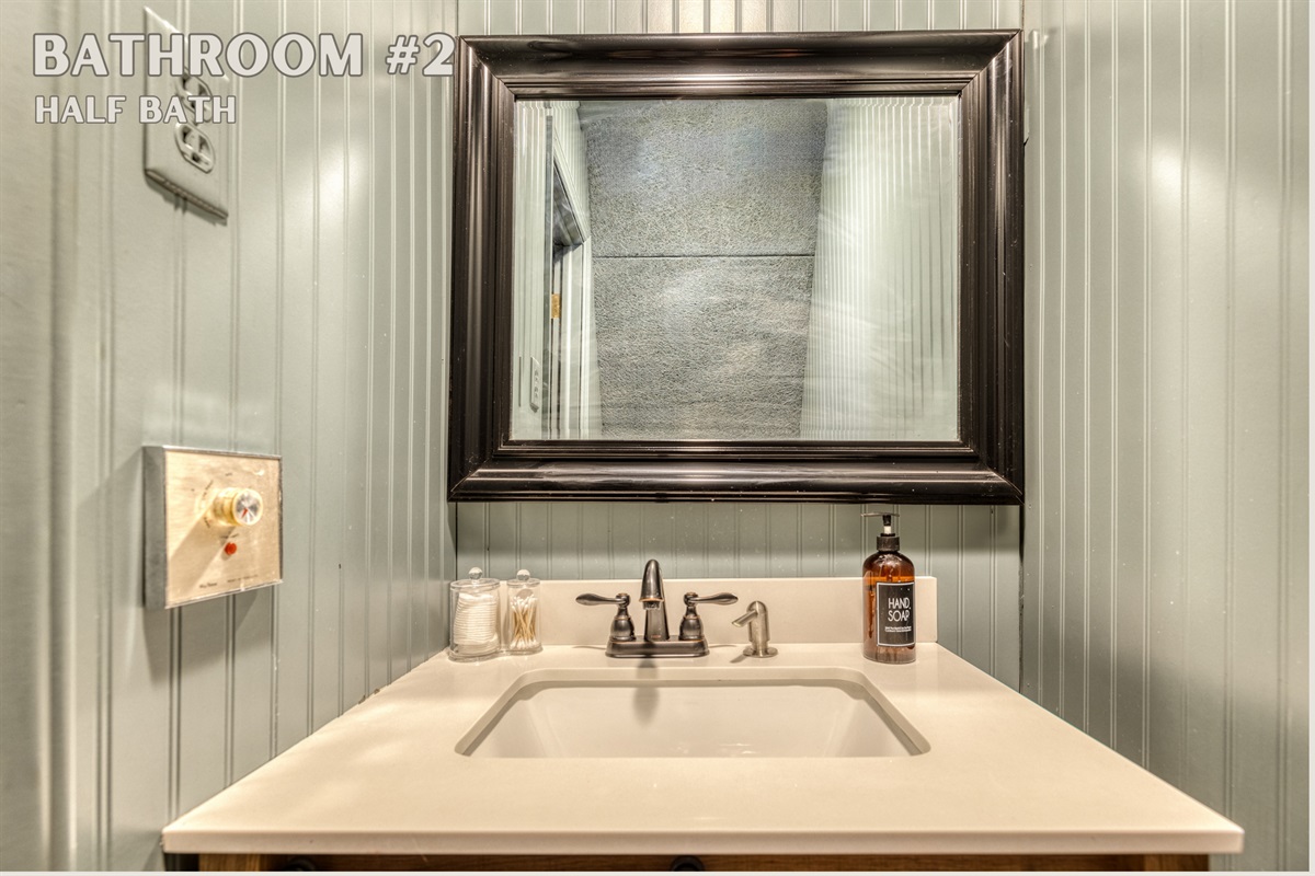 Bathroom #2, an en-suite half bath, offers convenience and style with its sleek sink and modern fixtures. This private space adds a touch of luxury to your stay.