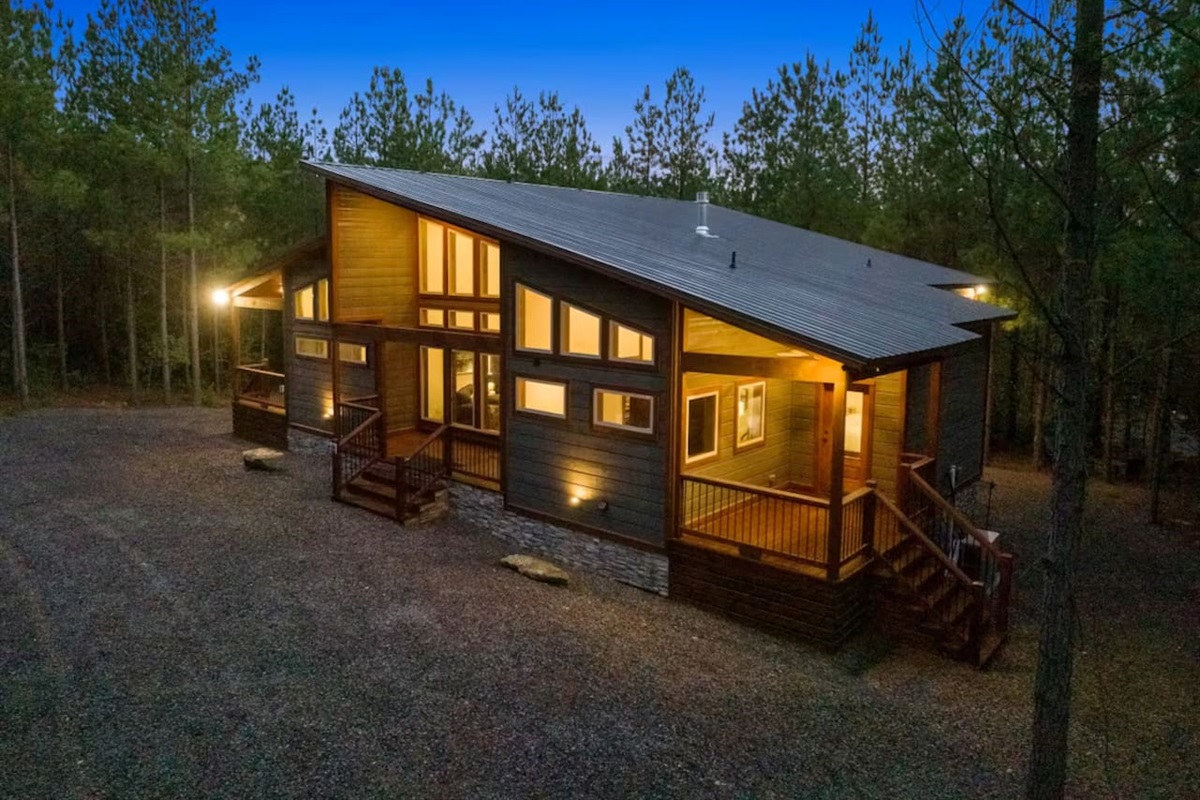 Designed for both comfort and curb appeal, this cabin’s beautiful façade, expansive porches, and natural wood details set the tone for your ultimate forest getaway.