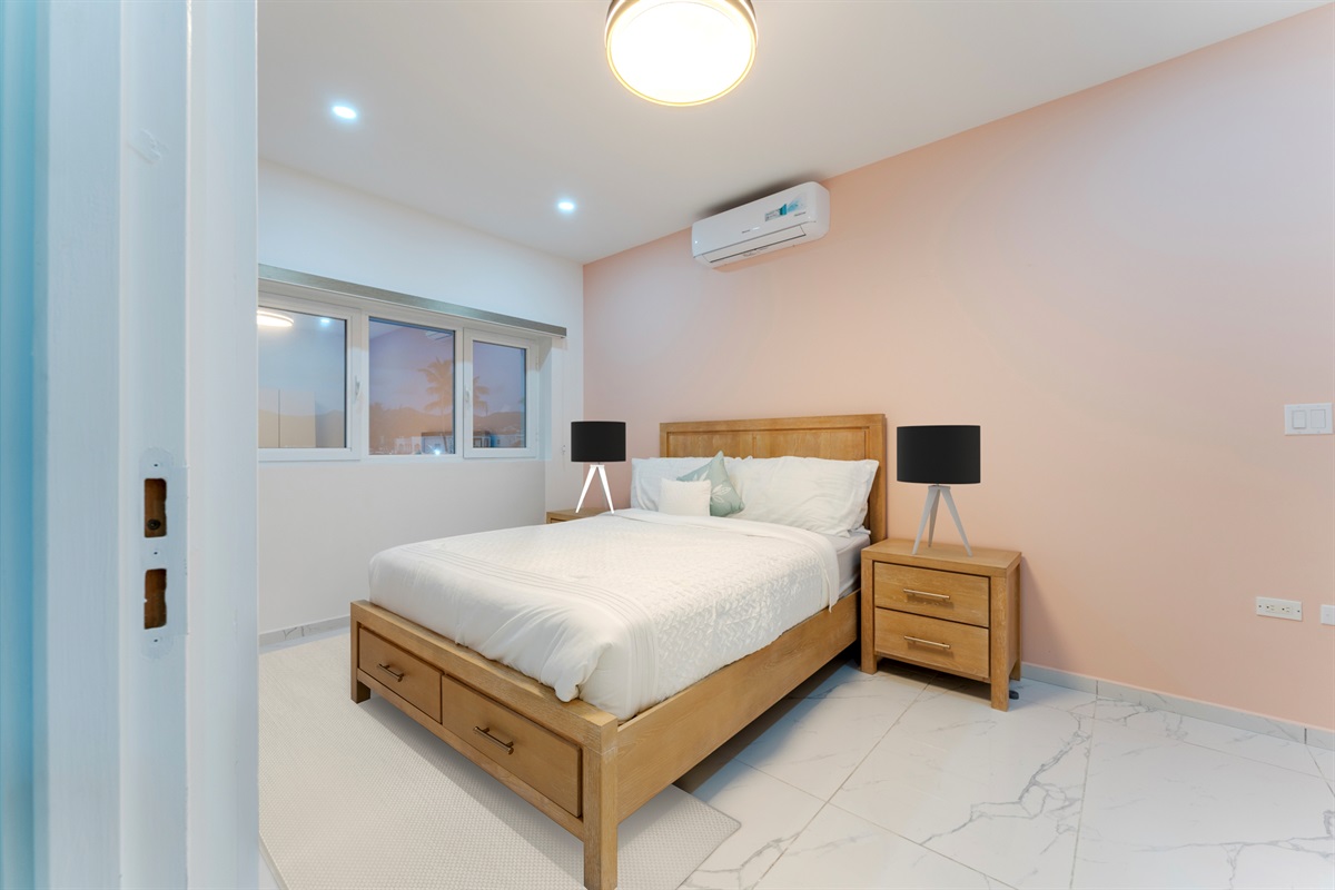 Wide shot of the second bedroom showcasing space, lighting and air conditioning