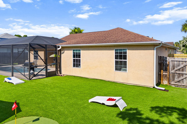 Toss some bean bags and relax! Our private backyard features a full cornhole game setup on beautiful artificial turf. Located beside the putting green and pool enclosure, it’s built for perfect afternoon entertainment.