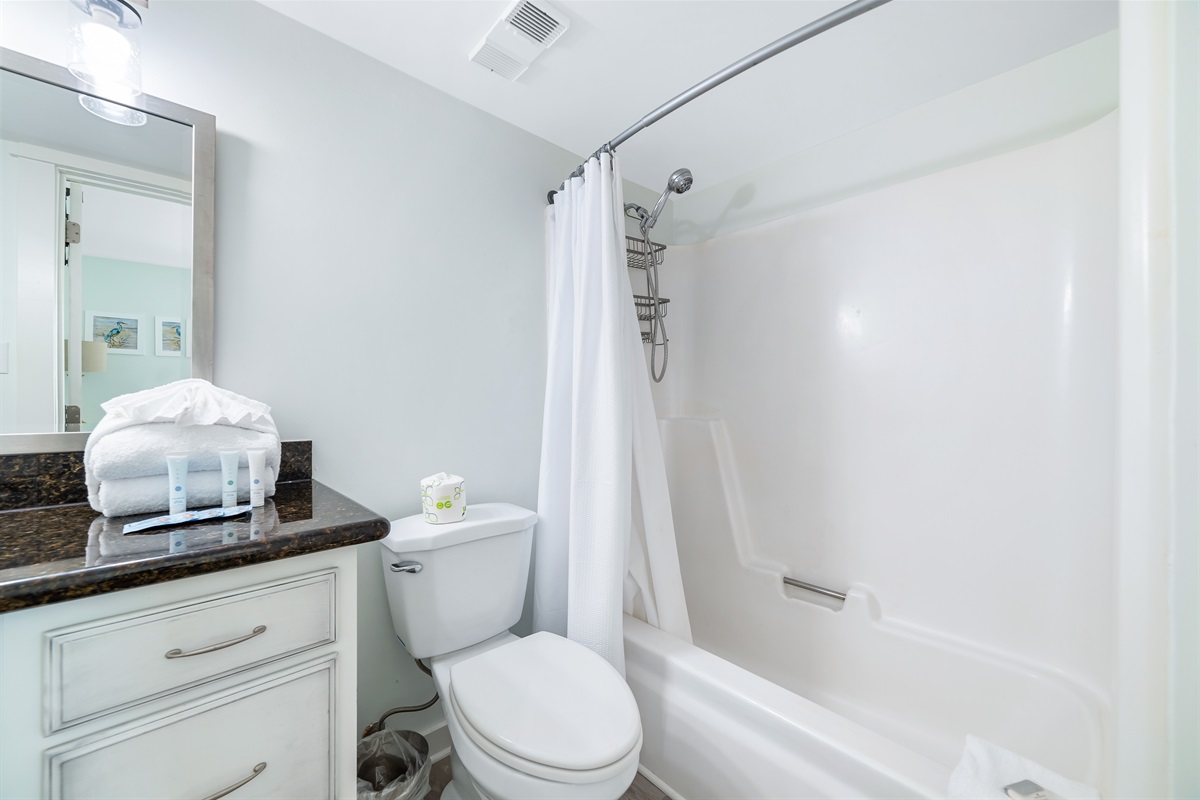 Freshly updated bathroom featuring a shower/tub combination, ample vanity space, and modern fixtures.
