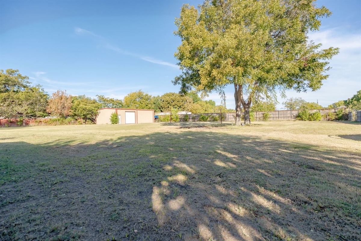 Backyard view of your spacious Grand Prairie getaway — close to EpicCentral and AT&T Stadium.
