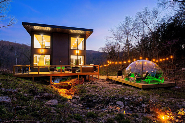 Discover your private retreat nestled in the woods - a glass cabin built above the flowing creek with abundant lighting features, and unique stargazing dome.