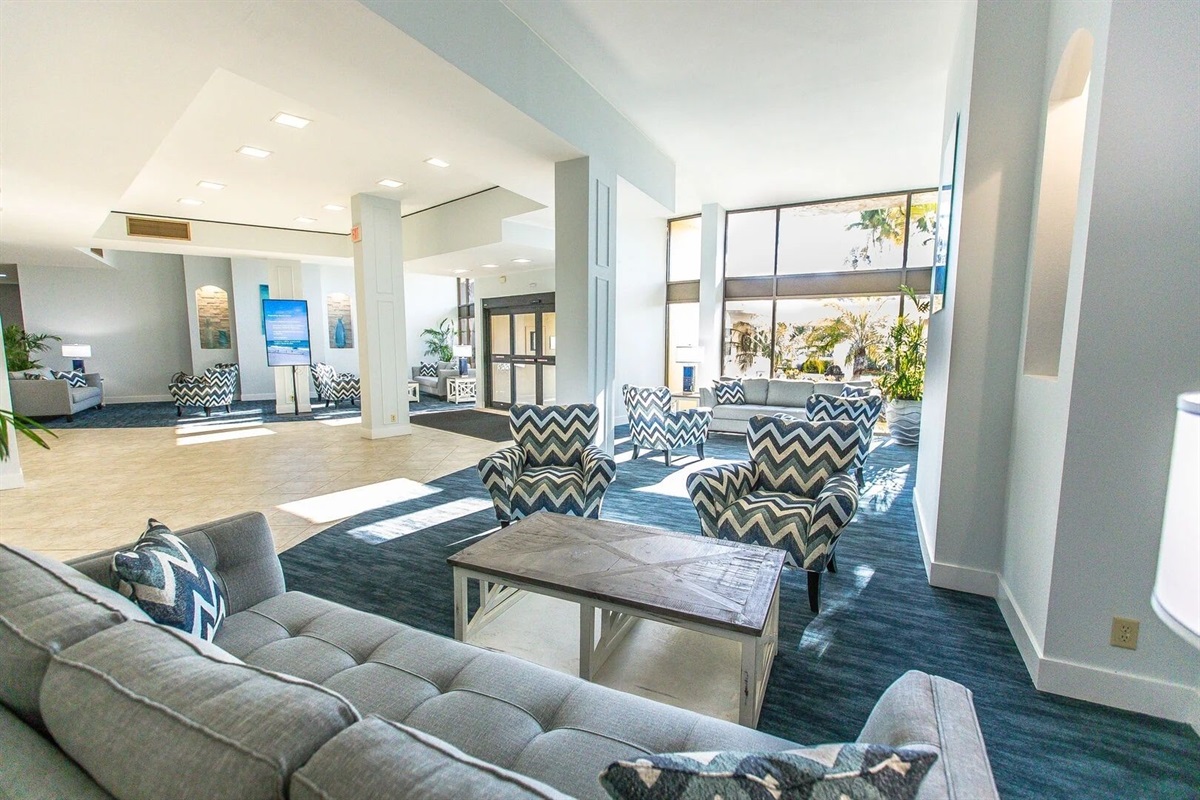 Indoor lounge area with water views and chic beach-inspired design.