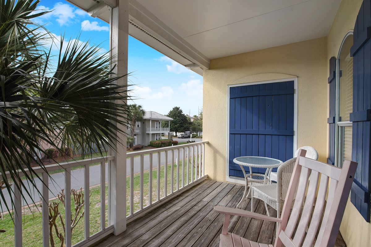 Balcony seating area overlooking palm trees
