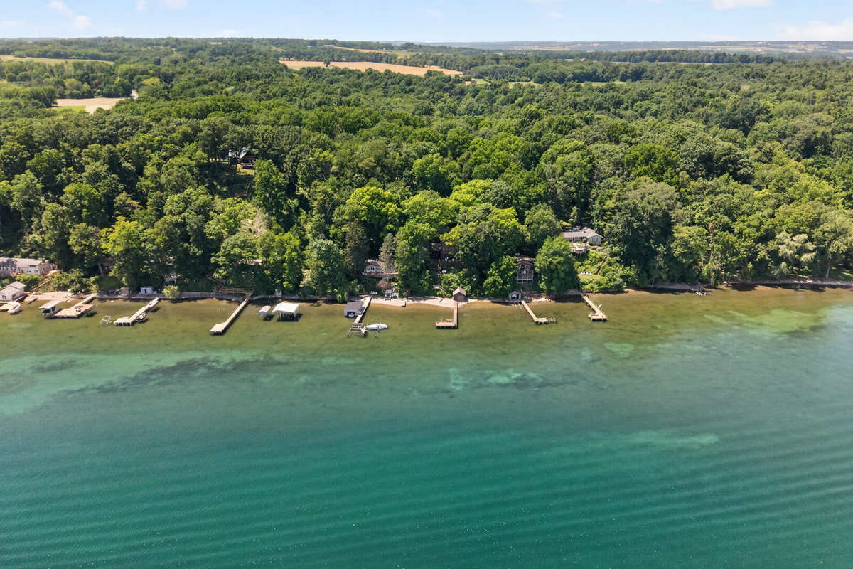 Wide aerial view of the forested lakeshore
